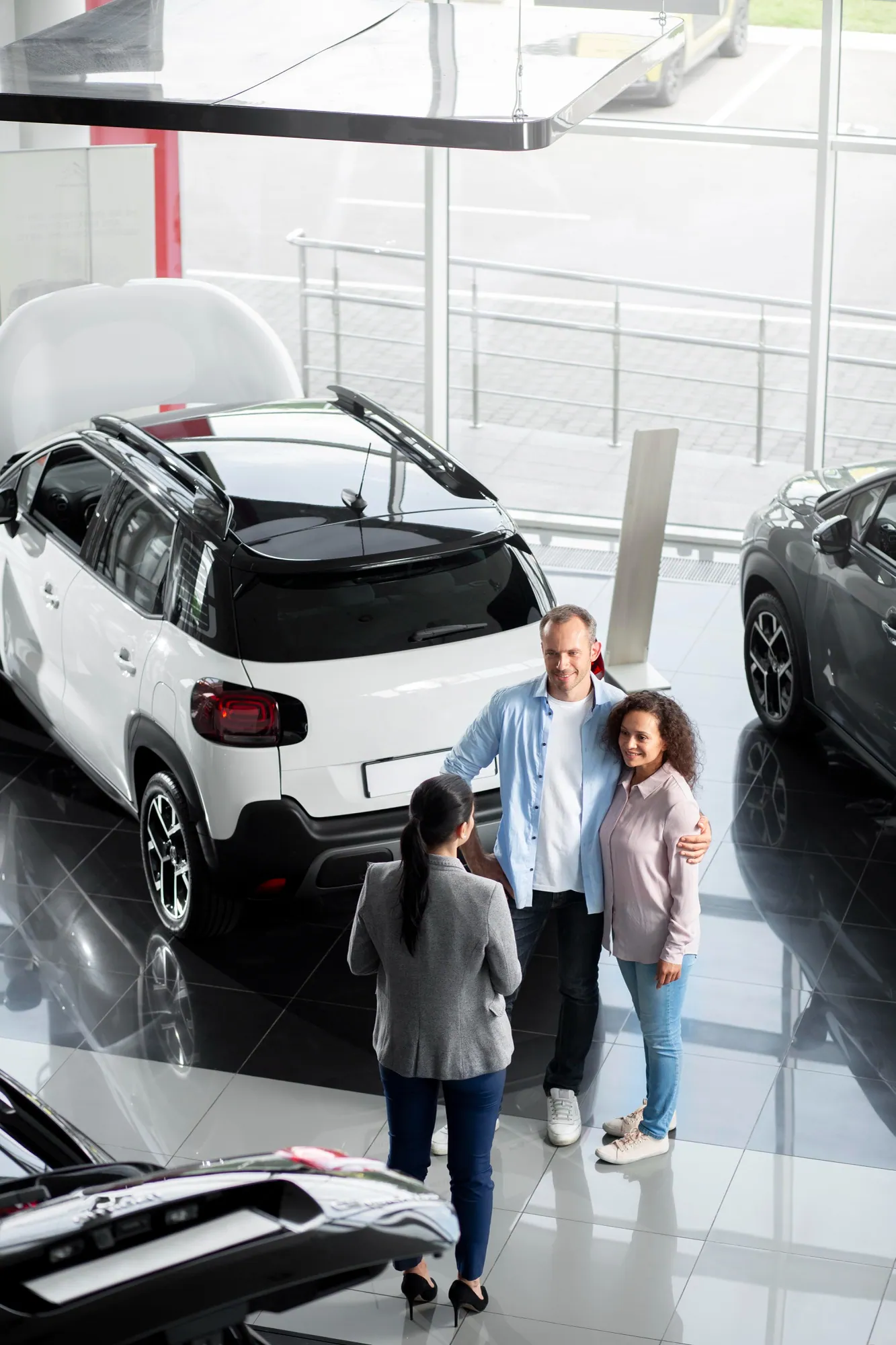 A family being helped by a salesperson at a dealership